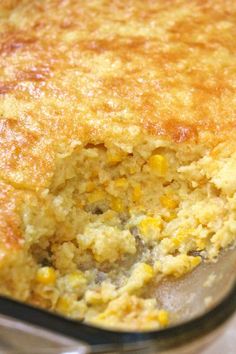 a casserole dish with corn and cheese in it's center, ready to be eaten