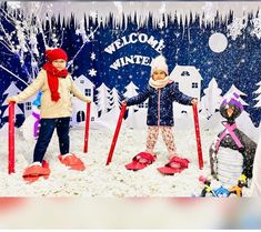 two children are standing in the snow with skis