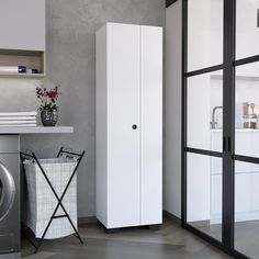 a laundry room with a washer and dryer next to each other on the floor