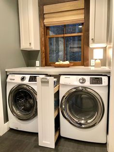 a washer and dryer in a small room with wooden window sill above them