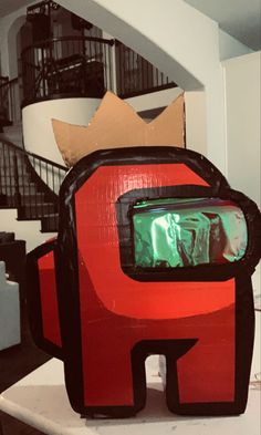 a red and black bag sitting on top of a table next to a stair case