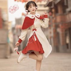 a woman in a red and white dress is dancing on the street with an umbrella