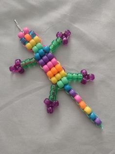 a multicolored beaded cross on a white sheet