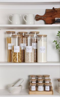 spices and other items on shelves in a kitchen