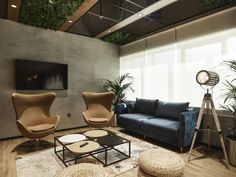 a living room filled with furniture and a flat screen tv mounted to the side of a wall