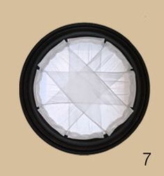 an image of a round light fixture with the number 7 on it's side