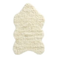 a white sheepskin rug is shown on a white background, with the top part of it