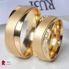 two gold wedding rings with diamonds on them