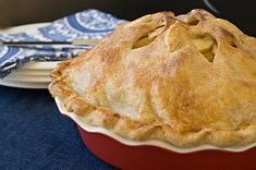 an apple pie sitting on top of a blue table