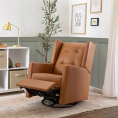 a brown recliner chair sitting on top of a wooden floor