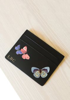 Our Butterflies Bag features our one-of-a-kind motif with its beautiful array of colors set for flight. Details: Double cardholder. Space for four cards. Additional slot in the middle. Dimensions: H 3" x W 4" Click Here To Shop Butterflies Collection Click Here For Our Monogram Menu Painted by hand. 100% Vegan leather outer. Fabric lining. Consciously crafted. One-of-a-kind. Supports the creative community. Wallet Art, Butterfly Bags, Handmade Stuff, Painted Bags, Its Beautiful, Birthday Party Balloon, Butterfly Cards, Painting Leather, Leather Bags Handmade