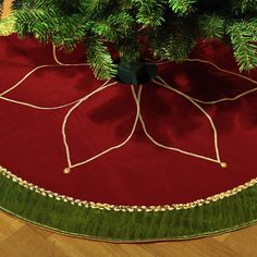 a small christmas tree on top of a red rug