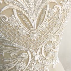 the back of a wedding dress with beading on it