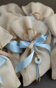 several bags with blue ribbons and gold rings on them