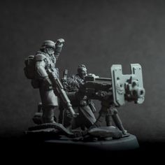 a couple of toy soldiers standing next to each other on top of a black and white photo