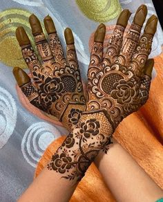 the hands are decorated with henna designs