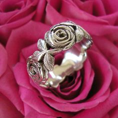 This is one of the few Designs of mine that I made for myself .  I spent a long time looking at , drawing then creating a realistic looking Rose .  I love the simplicity and classic design of my Rose Ring .  It is one of my most favourite Ring designs that I have created .... that is why I wear it as my Wedding Ring .   WIDTH  9.5 mm THICKNESS2.4 mm SIZE     Please contact me regarding Ring Size .    HALLMARKED 925  PLEASE NOTE This price is for a ring up to a size S in UK sizing  /   Size 9 1/8 in US sizing . A sizing fee will be charged for larger sizes than this ....   Contact me before you buy and I will give you an accurate price.  Please Note : Due to the nature of the Rose Ring it is impossible at times to make the ring alternate between a Rose and the Leaf designs ....  Depending o My Wedding Ring, Two Roses, Silver Rose Ring, Pad Bag, Ring Hand, Rose Ring, Silver Wedding Rings, Love Rose, Rose Earrings