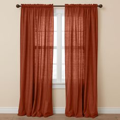 an orange curtain hanging in front of a window