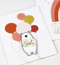 a card with balloons and a bear holding the number 50 on it's back