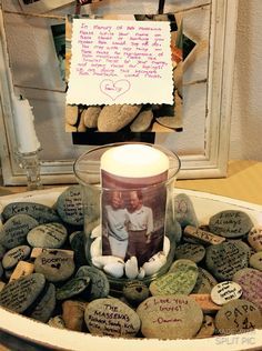 a candle sitting in a bowl filled with rocks