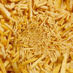 a pile of french fries sitting on top of a table