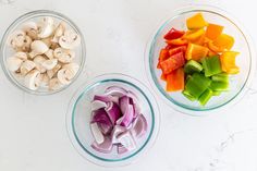 three bowls filled with chopped vegetables on top of a white counter next to each other