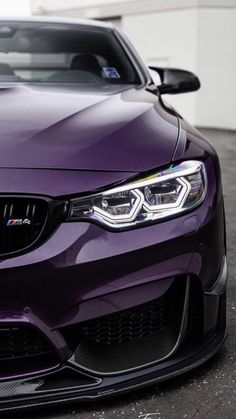 the front end of a purple car parked in a parking lot