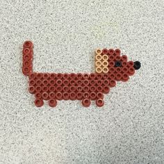 a beaded dachshund sitting on top of a counter