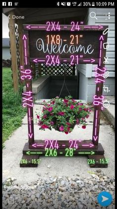 a welcome sign with pink flowers in it