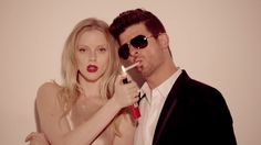 a man and woman with fake lipstick on their mouths posing for the camera while wearing sunglasses