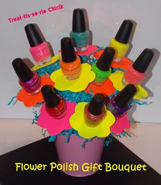 a vase filled with different colored nail polish bottles