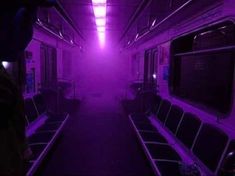 the inside of a train with purple lights