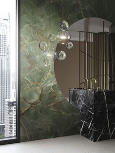 a bathroom with marble walls and flooring next to a large window