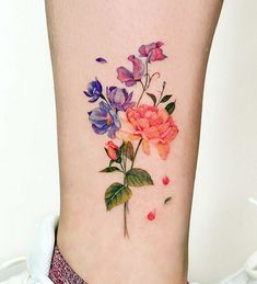 a woman's foot with flowers painted on the lower part of her leg and ankle