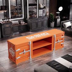 an orange storage unit with chrome handles in a room filled with black furniture and mirrors