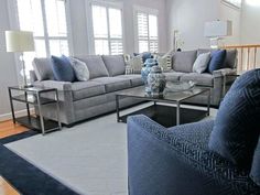 a living room filled with furniture and windows