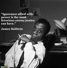 a man sitting in front of a desk with a quote from james baldwin on it