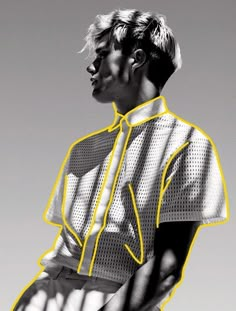 a black and white photo of a man wearing a shirt with yellow lines on it