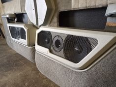 two speakers sitting on the back of a vehicle