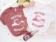 "This Gettin' Hitched and Gettin' Rowdy shirt, is perfect for each party goer at the Bachelorette party. This shirt will be perfect for any Western themed Bachelorette party or just some fun time in the city . ♥ HOW TO ORDER ♥ 1. Select the \"Shirt Style + Size\" (see images for options). 2. Select the \"Shirt Color\" 3. Enter custom text under Personalization.  4. Add to cart and checkout  S I Z I N G   &   C O L O R S - Please refer to sizing and color charts in the images U N I S E X    T S H I R T  P R O D U C T   D E T A I L S - Printed with ink - Unisex Tshirt - The collar is ribbed knit, so it retains its shape even after washing. - Loose fit for a comfortable feel F A B R I C A T I O N  - Solid colors are 100% cotton except Ash - 99% cotton and 1% polyester,  - Heather colors are 5 Casual Pink T-shirt For Bachelorette Party, Pink Short Sleeve T-shirt For Bachelorette Party, Fitted Graphic Print Tops For Hen Party, Hen Party Short Sleeve T-shirt With Letter Print, Cotton Short Sleeve Tops For Hen Party, Short Sleeve T-shirt For Hen Party With Letter Print, Fitted Pink T-shirt For Hen Party, Pink Fitted T-shirt For Hen Party, Pink Short Sleeve Tops For Hen Party