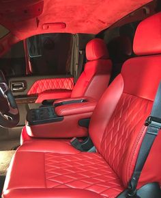 the interior of a car with red leather seats