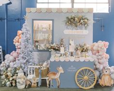 an ice cream cart decorated with balloons and stuffed animals is displayed in front of a christmas tree