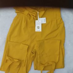 High Waisted Bow-Tie Waist And Legs. Pleated, Mustard Yellow Color. Brand New In Bag. Grace Karin Pants, Paper Bag Pants, Bag Pants, Mustard Yellow Color, Mustard Yellow, Yellow Color, Bow Tie, Pant Jumpsuit, Mustard