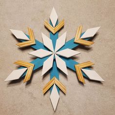 an origami snowflake made out of wood and paper