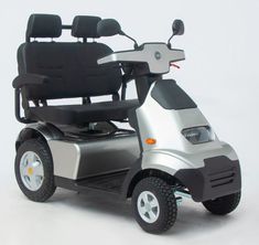 a silver scooter with black seats on a white background