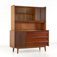 a wooden cabinet with glass doors and drawers on it's sides, against a white background