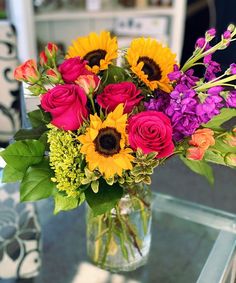 a vase filled with colorful flowers on top of a table