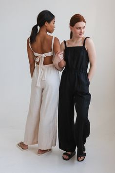 "Chic linen jumpsuit with eye-catching open back details. Comfy yet worthy of any occasion. Offered in medium-weight linen. STYLE DETAILS * Regular fit * Square neckline * Slightly ruffled elastic straps * Elastic waistline * Ties at the back * Full length * Pockets in side seams * Made from medium-weight linen SIZES & COLORS IN THE PICTURES * Model 1 is wearing size S/M in Buttercream (medium) linen. Model's height - 175 cm (5'9\"), bust - 80 cm (31.5\"), waist - 60 cm (23.6\"), hips - 92 cm (3 Loose Linen Overalls, Summer Linen Jumpsuits And Rompers For Vacation, Summer Vacation Linen Jumpsuits And Rompers, Summer Beach Linen Jumpsuits And Rompers, Relaxed Fit Overalls For Vacation, Elegant Sleeveless Linen Jumpsuit, Chic Cotton Wide-leg Jumpsuits And Rompers, Chic Cotton Wide Leg Jumpsuits And Rompers, Chic Loungewear Jumpsuits And Rompers With Tie Straps