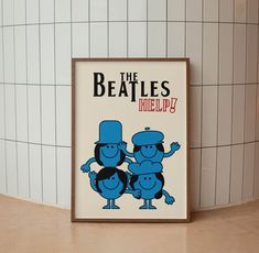 the beatles help poster is displayed in front of a white tiled wall with blue tiles