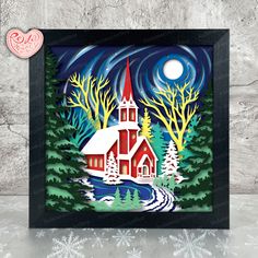 a paper cut christmas scene with a church in the woods